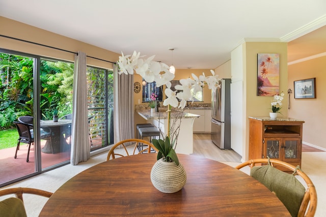 3920 Wyllie Rd Unit 6A, Princeville, HI 96722 - dining room featuring crown molding and light wood-style floors
