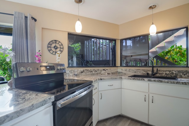 3920 Wyllie Rd Unit 6A, Princeville, HI 96722 - kitchen featuring electric stove, white cabinets, wood finished floors, and pendant lighting