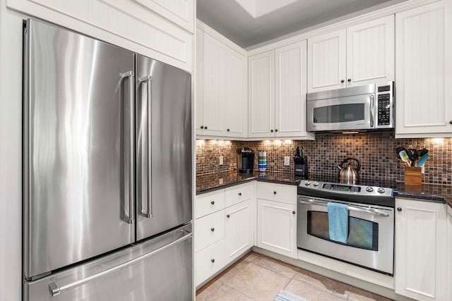 68-1118 N Kaniku Dr Unit 2404, Kamuela, HI 96743 - kitchen featuring stainless steel appliances, tasteful backsplash, light tile patterned floors, and white cabinetry