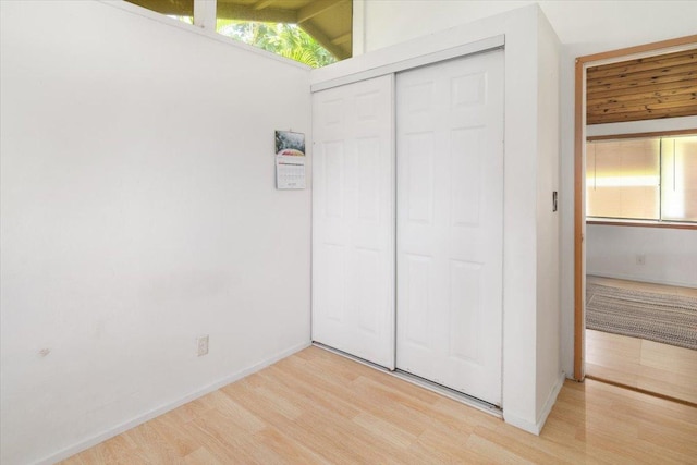 15-2775 Manalo St, Pahoa, HI 96778 - unfurnished bedroom featuring light wood-type flooring, a closet, multiple windows, and lofted ceiling