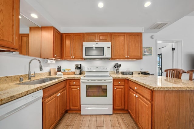 75-6040 Alii Dr Unit 714, Kailua-Kona, HI 96740 - kitchen featuring white appliances, a peninsula, light wood-style flooring, light stone countertops, and recessed lighting