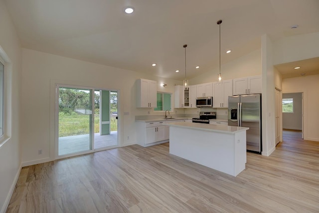 16-1653 34th Ave, Keaau, HI 96760 - kitchen featuring stainless steel appliances, light countertops, a center island, light wood-style floors, and healthy amount of natural light