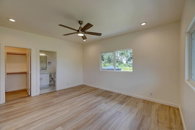 16-1653 34th Ave, Keaau, HI 96760 - unfurnished bedroom featuring light wood-style flooring, a spacious closet, recessed lighting, connected bathroom, and a closet