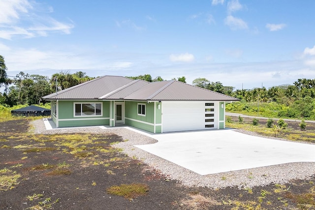 16-1653 34th Ave, Keaau, HI 96760 - view of front of house with driveway, a garage, and a metal roof
