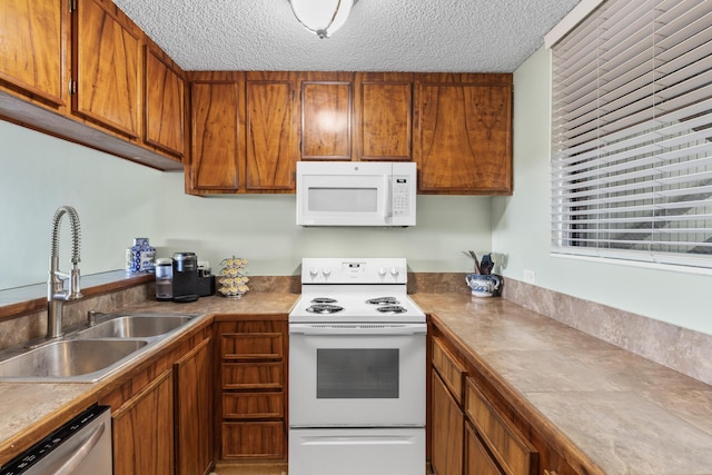 77-301 Noelani Way Unit 12, Kailua-Kona, HI 96740 - kitchen featuring white appliances, brown cabinets, a textured ceiling, and light countertops