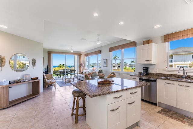 78-6833 Alii Dr Unit C5, Kailua-Kona, HI 96740 - kitchen with stainless steel dishwasher, dark stone countertops, a kitchen island, open floor plan, and healthy amount of natural light