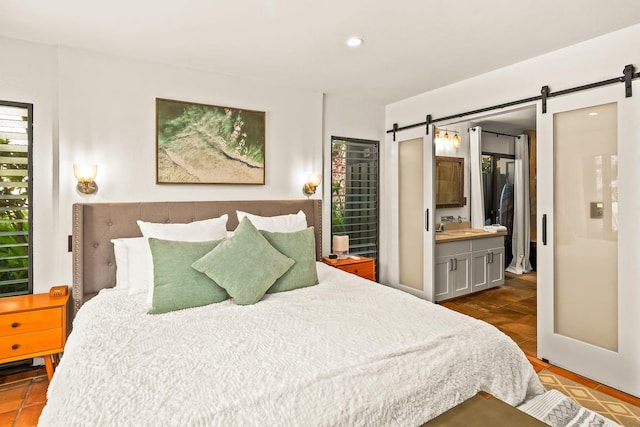 3920 Wyllie Rd Unit 10A, Princeville, HI 96722 - tiled bedroom with a barn door, recessed lighting, and ensuite bathroom
