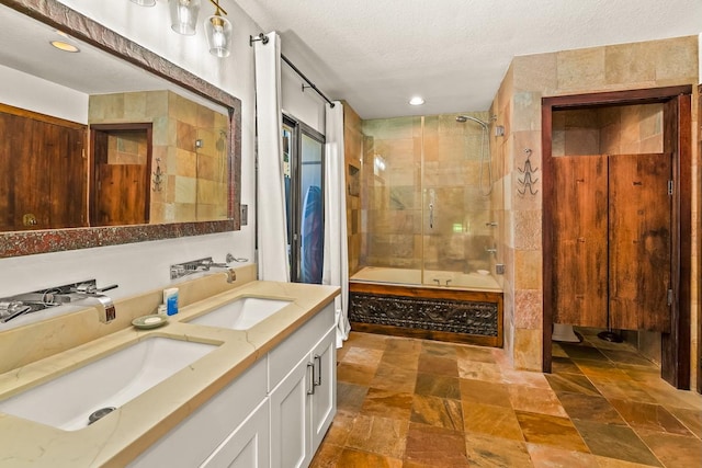 3920 Wyllie Rd Unit 10A, Princeville, HI 96722 - bathroom featuring double vanity, a textured ceiling,  shower combination, stone finish flooring, and recessed lighting