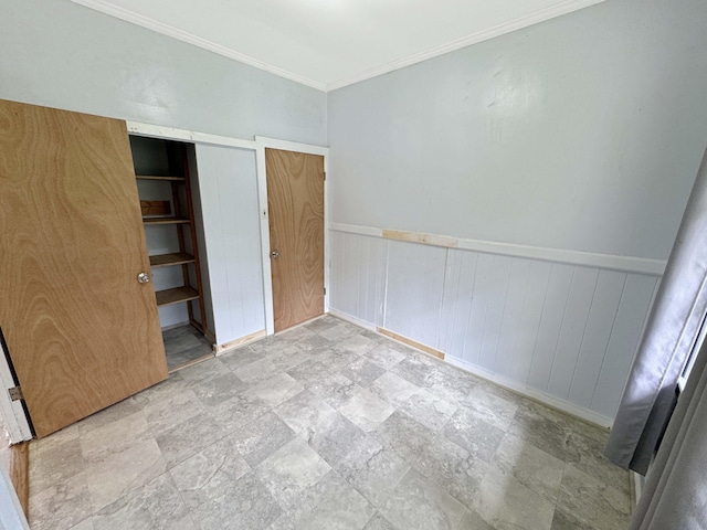 17-312 Volcano Rd, Kurtistown, HI 96760 - unfurnished bedroom featuring stone finish flooring, ornamental molding, and a wainscoted wall