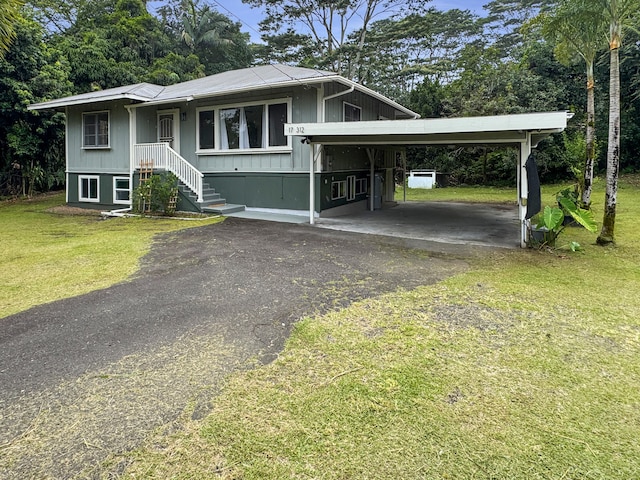17-312 Volcano Rd, Kurtistown, HI 96760 - view of front of home with driveway, a front lawn, and view of scattered trees