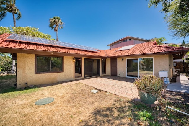 68-1768 Niu Haohao Pl, Waikoloa, HI 96738 - back of house featuring stucco siding, a tiled roof, and solar panels