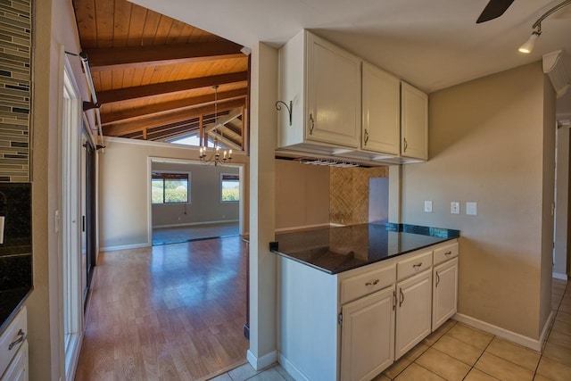 68-1768 Niu Haohao Pl, Waikoloa, HI 96738 - kitchen with wooden ceiling, dark countertops, tasteful backsplash, white cabinets, and a chandelier