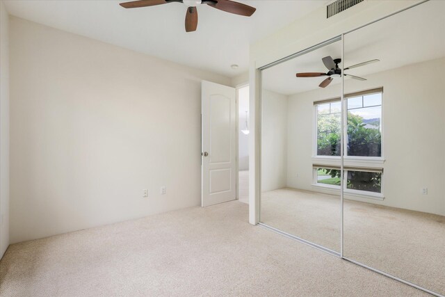 75-6060 Kuakini Hwy Unit E4, Kailua-Kona, HI 96740 - unfurnished bedroom with carpet, a closet, and a ceiling fan