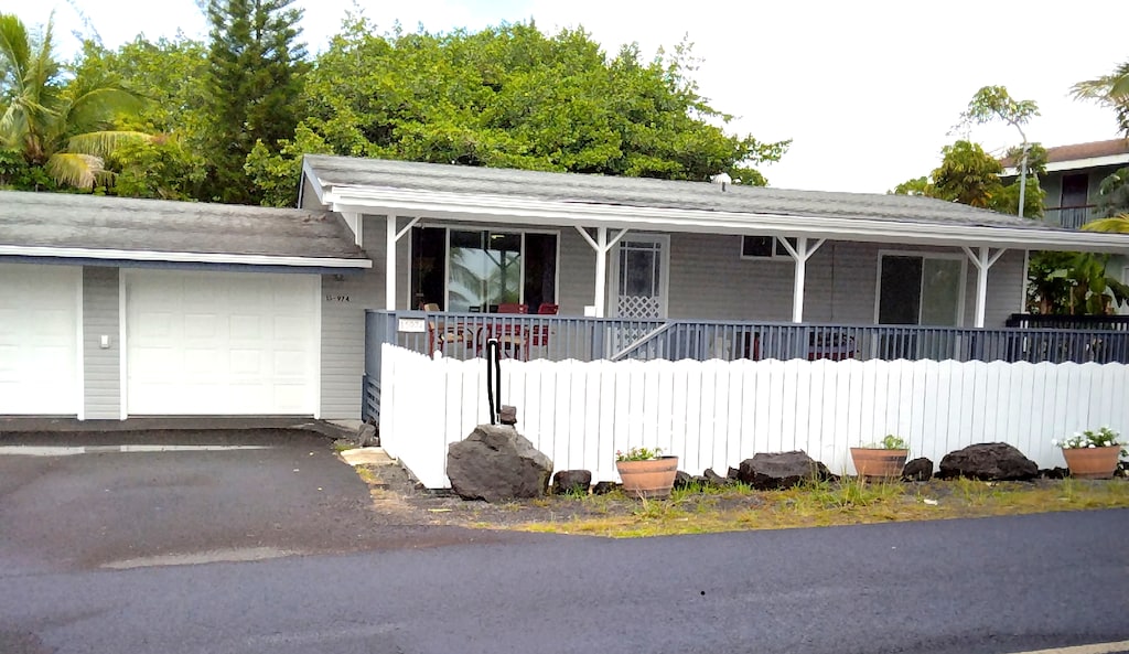 15-974 Paradise Ala Kai Dr, Keaau, HI 96749 - ranch-style home featuring covered porch, a garage, and asphalt driveway
