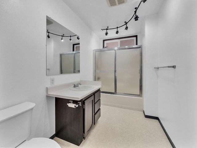 15-974 Paradise Ala Kai Dr, Keaau, HI 96749 - bathroom featuring rail lighting, vanity, and enclosed tub / shower combo