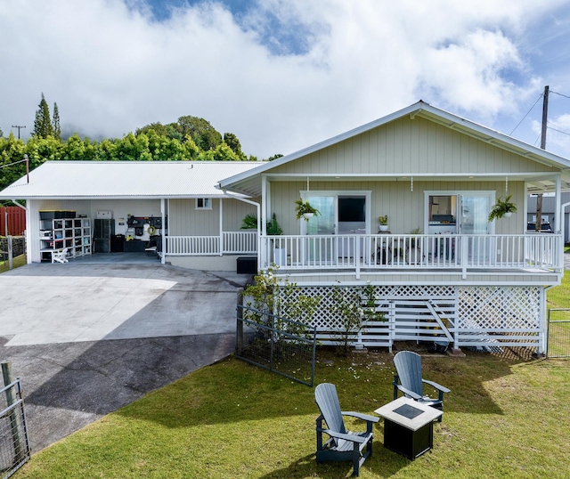 64-5246 Puu Nani Dr, Kamuela, HI 96743 - view of front of home featuring a front lawn, a porch, a fire pit, and concrete driveway