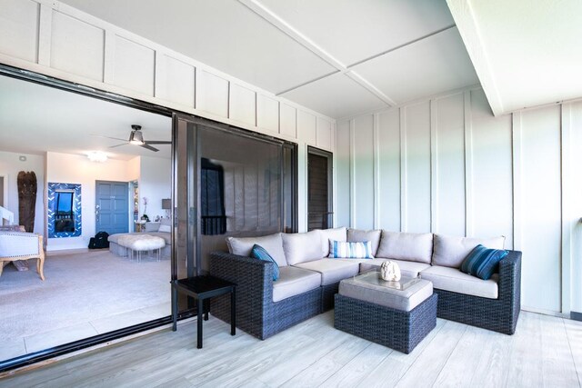 1565 Pee Rd Unit 122, Koloa, HI 96756 - living area with light wood-type flooring, a decorative wall, and ceiling fan