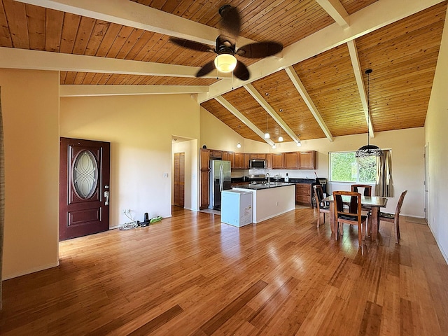 16-2110 Pearl Dr, Pahoa, HI 96778 - kitchen with appliances with stainless steel finishes, dark countertops, open floor plan, a ceiling fan, and light wood-style flooring