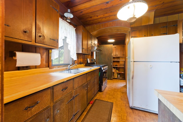 16-1331 Opeapea Rd, Mountain View, HI 96760 - kitchen featuring freestanding refrigerator, gas range, wood ceiling, light countertops, and arched walkways