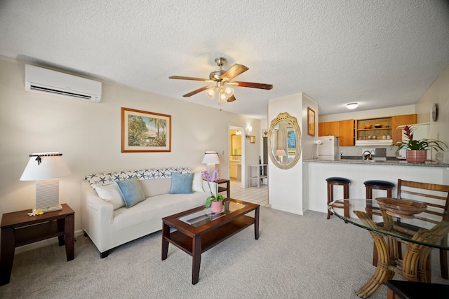 525 Aleka Lp Unit F15, Kapaa, HI 96746 - living room with a wall mounted AC, ceiling fan, light carpet, and a textured ceiling