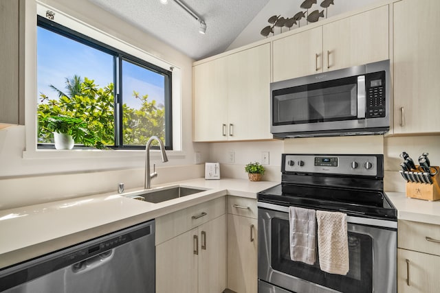 3700 Kamehameha Rd Unit H5, Princeville, HI 96722 - kitchen with appliances with stainless steel finishes, light countertops, a textured ceiling, vaulted ceiling, and light brown cabinetry