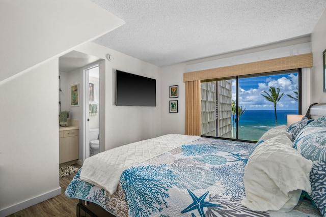 3700 Kamehameha Rd Unit H5, Princeville, HI 96722 - bedroom featuring access to outside, wood finished floors, a textured ceiling, and connected bathroom