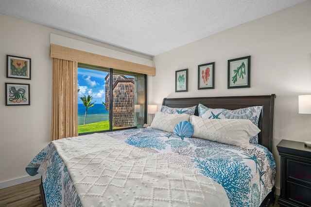 3700 Kamehameha Rd Unit H5, Princeville, HI 96722 - bedroom with wood finished floors and a textured ceiling