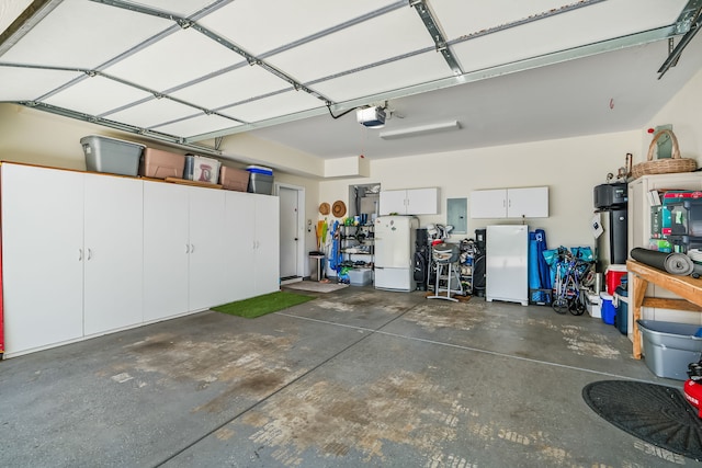 4919 Pepelani Lp Unit 2A, Princeville, HI 96722 - garage with refrigerator, electric panel, and a garage door opener