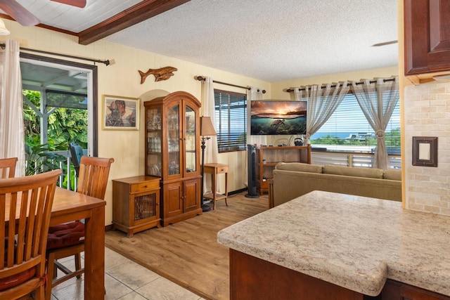 76-6132 Plumeria Rd, Kailua-Kona, HI 96740 - dining room featuring a ceiling fan, healthy amount of natural light, light wood-style flooring, and a textured ceiling
