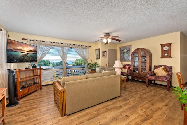 76-6132 Plumeria Rd, Kailua-Kona, HI 96740 - living area featuring a textured ceiling, light wood finished floors, and ceiling fan