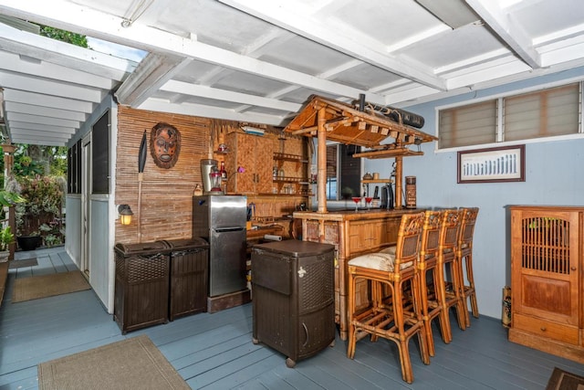 76-6132 Plumeria Rd, Kailua-Kona, HI 96740 - indoor dry bar featuring freestanding refrigerator, wood walls, wood finished floors, and beam ceiling