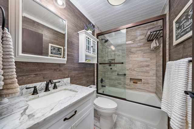 76-6132 Plumeria Rd, Kailua-Kona, HI 96740 - full bath with vanity, shower / bath combination with glass door, wooden walls, and tile patterned flooring
