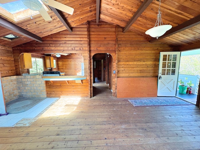 11-3927 8th St, Volcano, HI 96785 - unfurnished living room with arched walkways, ceiling fan, wood-type flooring, wood walls, and wood ceiling