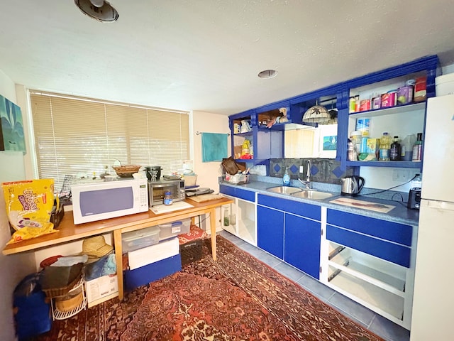 11-3927 8th St, Volcano, HI 96785 - kitchen with white appliances, open shelves, tile patterned floors, and blue cabinets