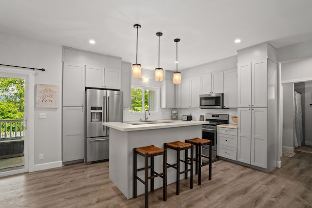 5970-A Heamoi Pl, Kapaa, HI 96746 - kitchen with appliances with stainless steel finishes, a center island, tasteful backsplash, light countertops, and recessed lighting