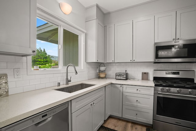 5970-A Heamoi Pl, Kapaa, HI 96746 - kitchen featuring stainless steel appliances, light countertops, backsplash, and dark wood finished floors