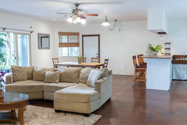73-1599 Hao St, Kailua-Kona, HI 96740 - living area featuring ceiling fan, healthy amount of natural light, and finished concrete floors