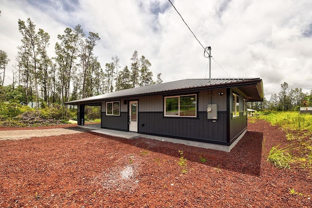 16-2069 Azure Dr, Pahoa, HI 96778 - view of front of property featuring a carport, a metal roof, and a patio area