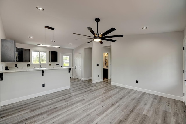 16-2069 Azure Dr, Pahoa, HI 96778 - unfurnished living room featuring light wood finished floors, recessed lighting, vaulted ceiling, and a ceiling fan