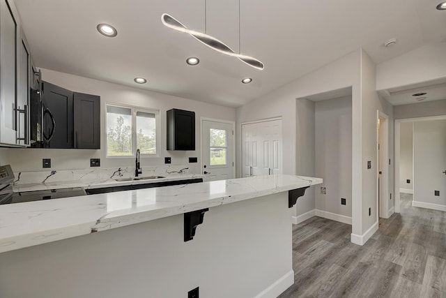 16-2069 Azure Dr, Pahoa, HI 96778 - kitchen featuring range, a breakfast bar, dark cabinets, lofted ceiling, and black microwave