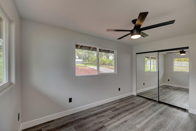 16-2069 Azure Dr, Pahoa, HI 96778 - unfurnished bedroom with wood finished floors, ceiling fan, and a closet