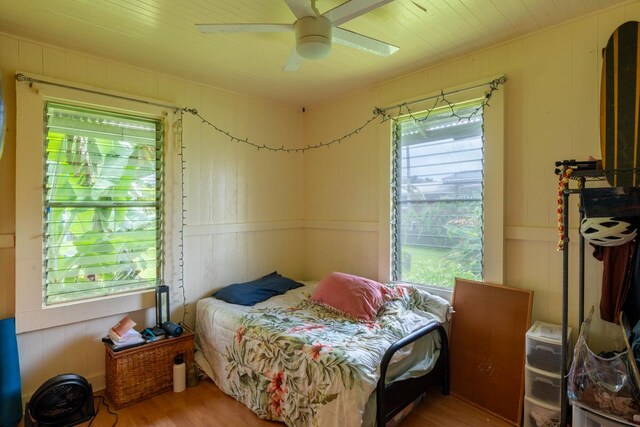 398 Ohai St, Hilo, HI 96720 - bedroom with wood finished floors, a decorative wall, and ceiling fan