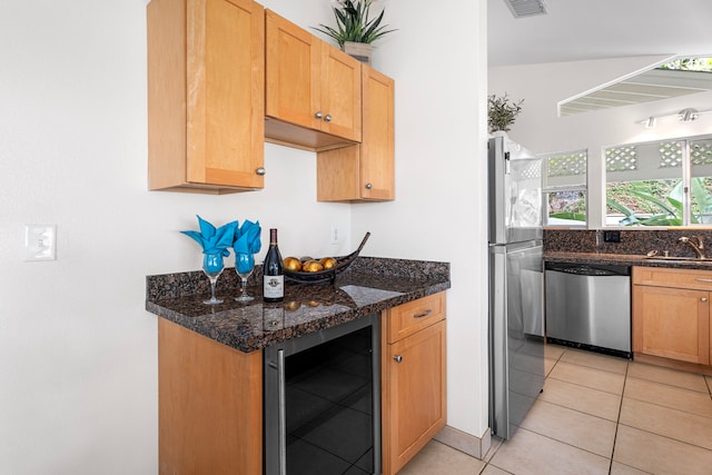 75-217 Nani Kailua Dr Unit 157, Kailua-Kona, HI 96740 - kitchen with wine cooler, appliances with stainless steel finishes, light tile patterned flooring, and dark stone countertops