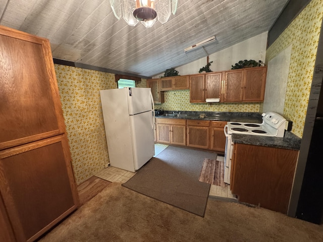 18-7855 Kulani Rd, Mountain View, HI 96771 - kitchen featuring white appliances, wallpapered walls, lofted ceiling, dark countertops, and brown cabinets
