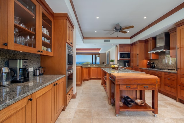 72-106 Hainoa Pl Unit 4, Kailua-Kona, HI 96740 - kitchen with wall chimney exhaust hood, black microwave, tasteful backsplash, double oven, and dark stone counters