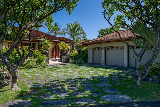 72-106 Hainoa Pl Unit 4, Kailua-Kona, HI 96740 - view of front of property with a garage, driveway, and stucco siding
