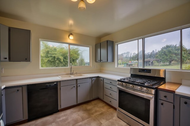 45-3463 Kahana Dr, Honokaa, HI 96727 - kitchen with black dishwasher, stainless steel gas range oven, gray cabinetry, and healthy amount of natural light