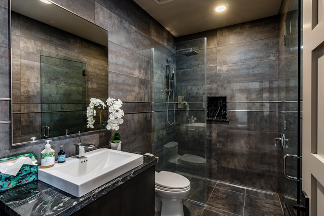 59-217 Lele Naia Dr, Kamuela, HI 96743 - bathroom featuring vanity, tiled shower, tile walls, and recessed lighting
