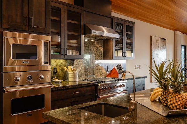 59-217 Lele Naia Dr, Kamuela, HI 96743 - kitchen featuring stainless steel appliances, range hood, dark brown cabinets, and dark stone counters