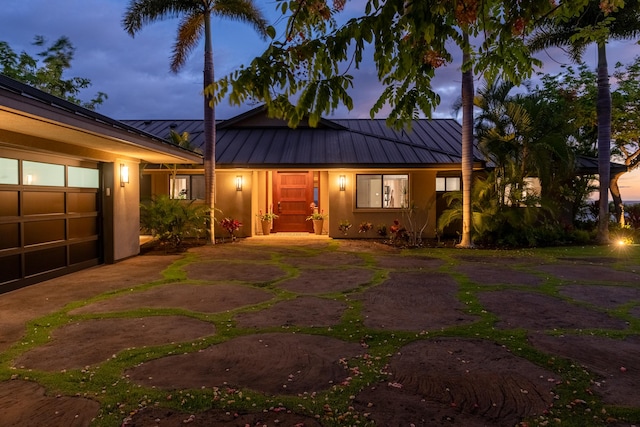 59-217 Lele Naia Dr, Kamuela, HI 96743 - view of front of home featuring a standing seam roof, a metal roof, stucco siding, driveway, and a garage